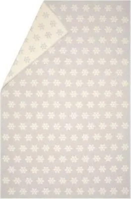A folded blanket with a snowflake pattern.