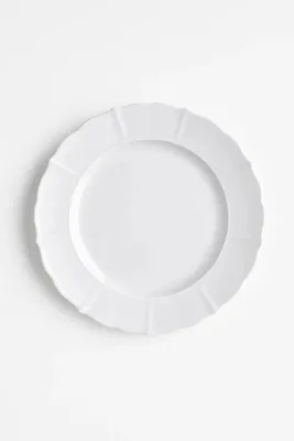 A white plate on a white background.