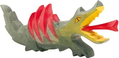 A wooden dragon toy with red spikes and a red tongue sticking out.