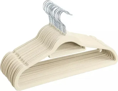 A stack of beige velvet hangers with silver hooks.