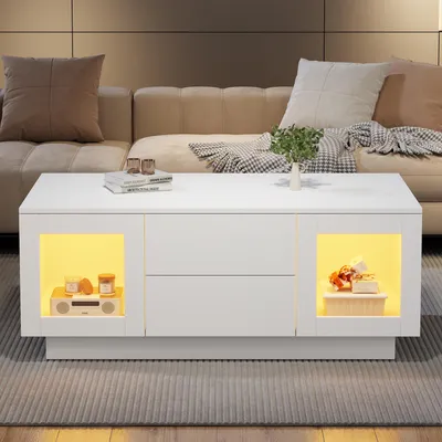 Imagen del producto de Mesa de centro de 100x50x40 cm con puertas de cristal, color blanco brillante, fabricada en MDF, con iluminación LED RGB regulable y 2 cajones, ideal para el salón