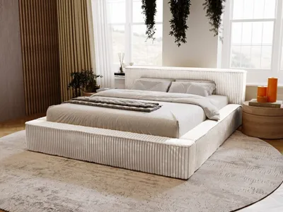 A modern bedroom with a large bed, curtains, and plants.