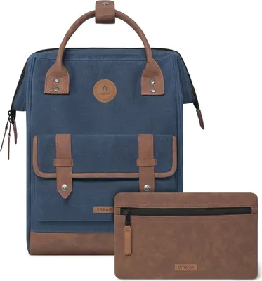 A blue backpack with brown leather accents and a matching brown pouch.