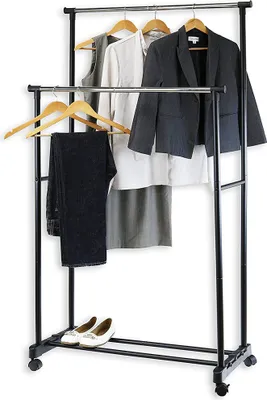 A double-bar garment rack with clothes and shoes.