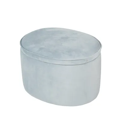 A light blue oval ottoman with a velvet texture is shown against a white background.