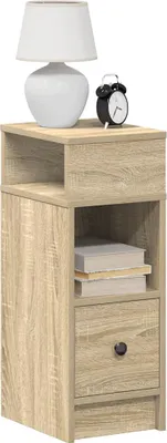A bedside table with a lamp and an alarm clock on top.