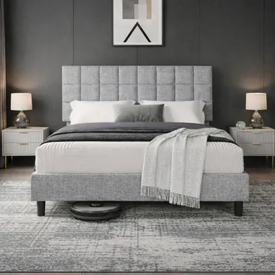 A bedroom scene with a bed, nightstands, and lamps.