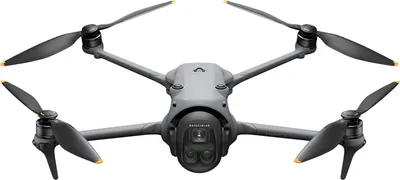 A gray drone with four propellers is shown from the front against a white background.