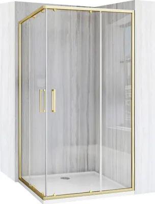 A shower enclosure with gold-colored frames and clear glass doors, set against a gray tiled wall.