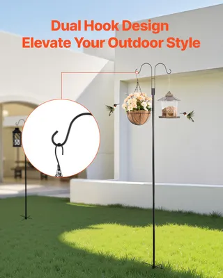 A garden scene with a dual hook shepherd's hook holding a hanging basket of flowers and a bird feeder. Two hummingbirds are shown near the feeder and basket.