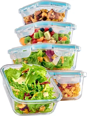 A stack of five glass food storage containers filled with various foods, including nuts, fruit salad, green salad, and pasta.