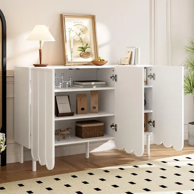 A white sideboard with its doors open, displaying shelves with various decorative items and storage boxes. The sideboard is placed on a rug in a room setting.