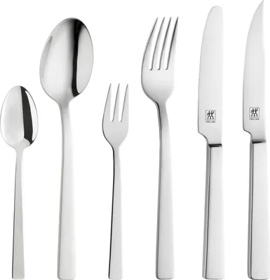 A set of silverware arranged on a white background.