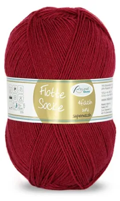 A ball of red yarn with a label wrapped around it.