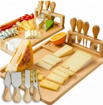 Two cheese boards with various cheeses, meats, and cheese knives.