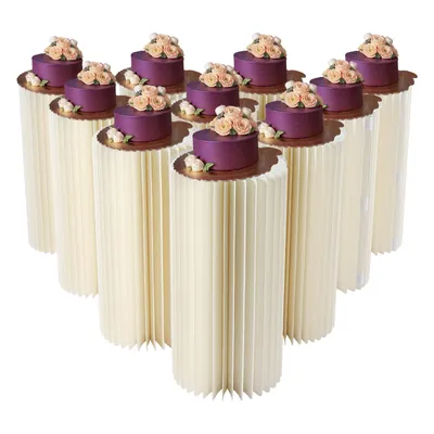 A display of multiple small cakes on decorative stands.