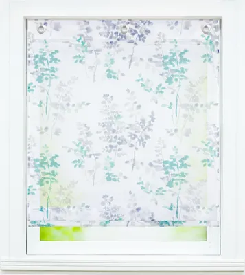 A close-up view of a roller blind with a floral pattern, hanging in a white window frame.