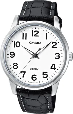 A close-up studio shot of a Casio watch with a white face and a black leather strap.