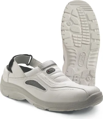 A pair of white work shoes, with the sole of one shoe prominently displayed.