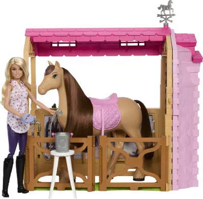 A Barbie doll and horse in a stable playset.