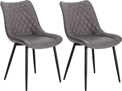 Two dark gray dining chairs with diamond-stitched upholstery and black metal legs are shown against a white background.