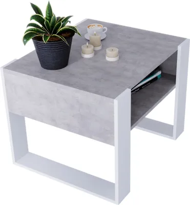 A modern coffee table with a plant, coffee cup, and candles on top.