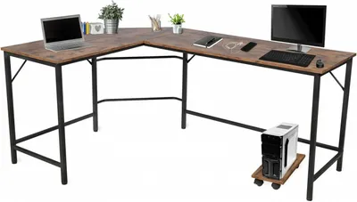An L-shaped desk with a laptop, monitor, keyboard, and computer tower on a white background.
