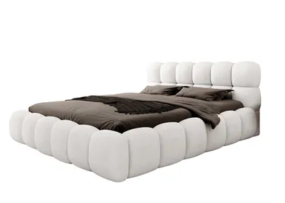 A white upholstered bed with brown bedding, shown against a white background.