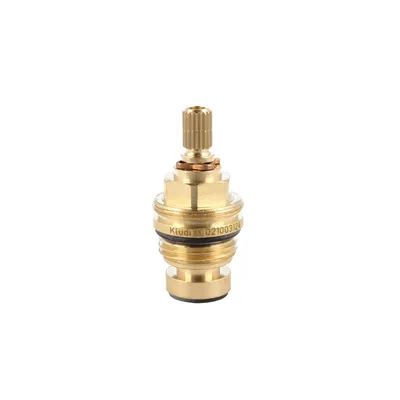 A close-up studio shot of a brass faucet cartridge on a white background.