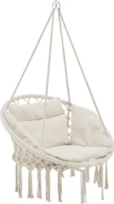 A cream-colored macrame hanging chair with cushions, suspended by ropes.