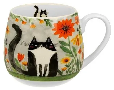 A ceramic mug with a black and white cat design and floral motifs.