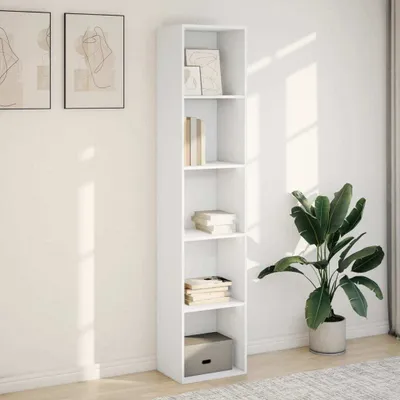 A white bookshelf filled with books and decorative items, placed against a white wall with sunlight casting shadows.