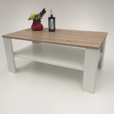 A coffee table with a wood-look top and white legs and shelf, displayed on a white background.