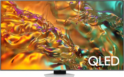 A Samsung QLED smart TV is displayed on its stand, showcasing a vibrant abstract image on its screen.