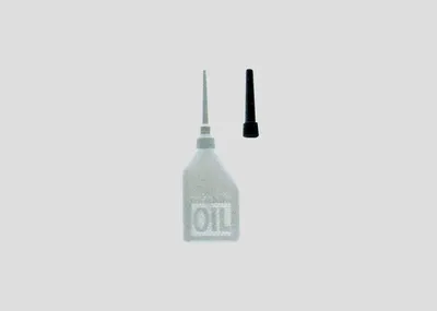 A clear shot of an oil bottle and its cap against a plain background.