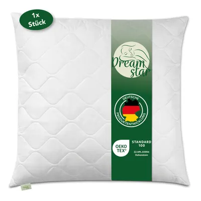 A white quilted pillow with a green band down the center featuring brand logos and certifications.