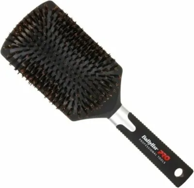 A black paddle hairbrush with brown bristles is shown against a white background.