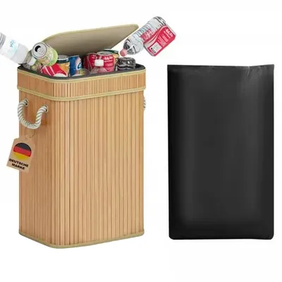 A bamboo recycling bin filled with bottles and cans, next to a black trash bag.