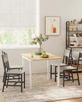 A dining set with chairs and a table in a well-lit room.