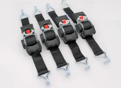 Four black ratchet straps with silver metal hooks and red release buttons are laid out diagonally on a white background.