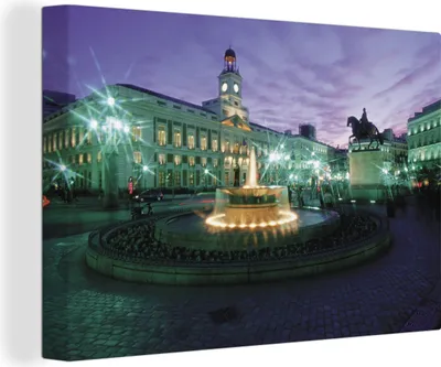 Zdjęcie produktu dla OneMillionCanvasses® - Wydruki na płótnie - 140x90 cm, Posąg i fontanna wieczorem na Puerta del Sol w Madrycie, grafika ścienna dekoracja ścienna