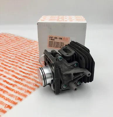 A STIHL cylinder and piston kit is shown next to its packaging.
