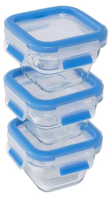A stack of three clear glass food storage containers with blue lids.