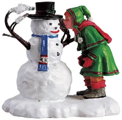 Neben dem Schneemann steht Kind. Es beugt sich vor und scheint dem Schneemann Kuss auf Nase zu geben