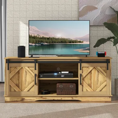 A TV stand with a television and electronic devices on it, placed in a living room setting.