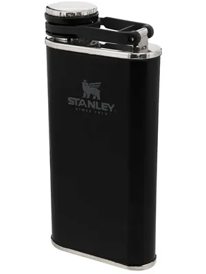 A black Stanley flask with a silver cap and silver trim at the bottom.
