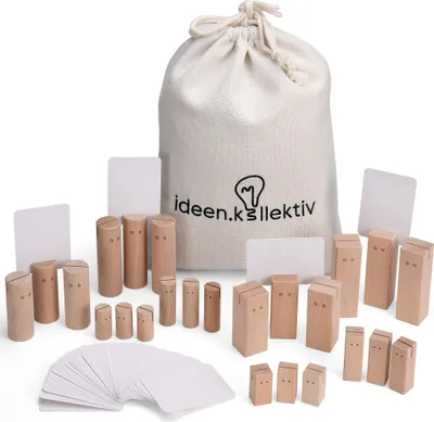 A collection of wooden figures and cards, along with a drawstring bag, are arranged on a white background. The figures are of various sizes and shapes, some resembling stylized people with carved features. The bag has a logo and text printed on it. Several