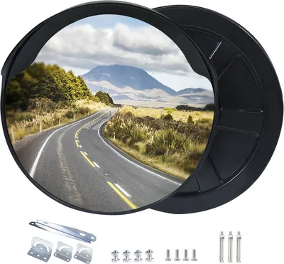 A convex mirror reflecting a scenic road and mountain landscape, with mounting hardware shown below.