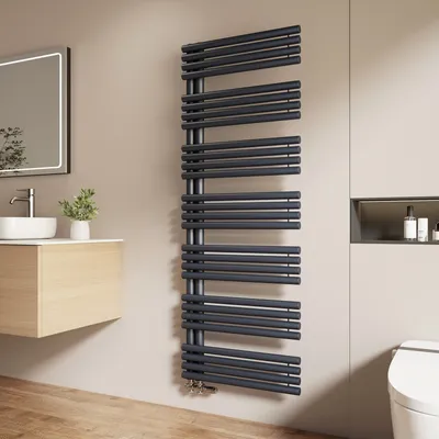 A modern bathroom with a sink, mirror, and a dark gray towel radiator.