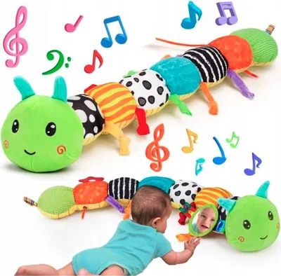 A baby is playing with a plush caterpillar toy. Musical notes are scattered around the toy, suggesting it plays music.